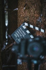 Movie slate board clapper seen through a blurred digital camera