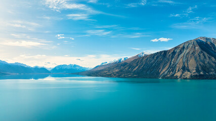 The untouched beauty of Lake Ohau surrounded by the snow capped southern alps mountain range