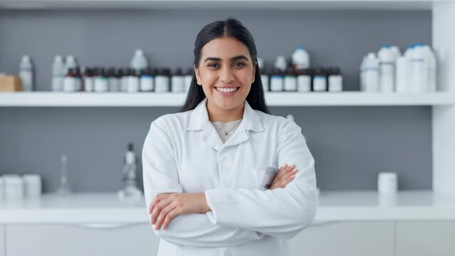 Phd scientist standing with arms crossed in a lab. Portrait of a happy indian woman working as a medical pathologist and clinical researcher feeling confident about her tests for a successful cure