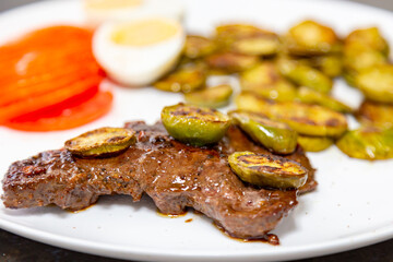The most traditional grilled beef liver with jiló. Brazilian rustic food