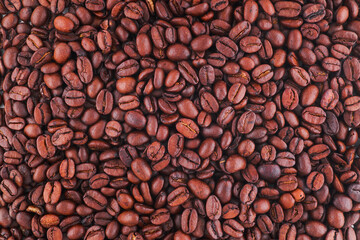 Freshly baked  dried coffee beans on background