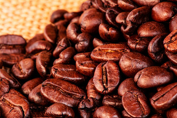 Freshly baked  dried coffee beans on background