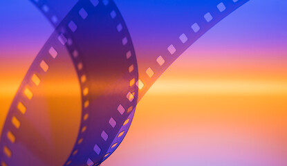 color background for cinema entertainment with film strip - obrazy, fototapety, plakaty