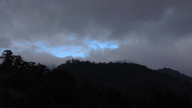Dusk to night. Beautiful clouds flying fast over mountain tops.Scenic landscape view and rapid fly cloud before the blast form a picturesque scene. High quality video photography in Hehuanshan,Taiwan	
