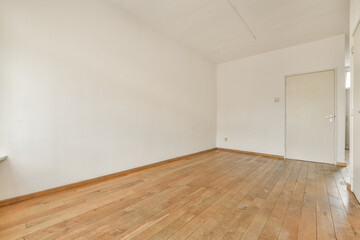 an empty room with wood flooring and white walls in the room is very clean, but there is no light