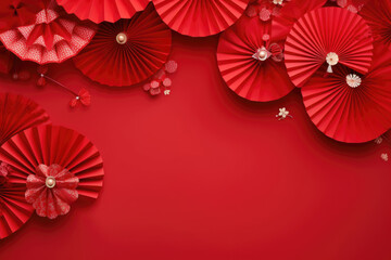 Fototapeta na wymiar Paper flowers and a fan on red background. Copy space. Mockup for Chinese New Year.
