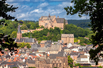 View of the castle on the mountain in the city of Marburg on a sunny summer morning. - obrazy, fototapety, plakaty