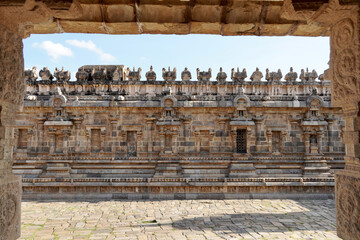 Temple wall with relief carvings. Stone wall of ancient Indian temple of Airavatesvara Temple,...