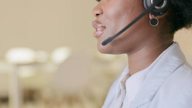 Closeup of a psychologist working at an online center, talking to her patient while wearing a headset in a modern office. Young healthcare worker giving support and advice during a therapy session