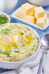 Traditional Irish dish Colcannon or mashed potato with green cabbage and butter, vertical