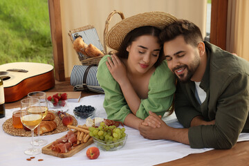 Romantic date. Beautiful couple spending time together during picnic in wooden gazebo