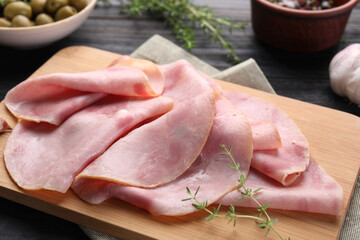 Slices of delicious ham with thyme on table, closeup