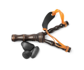 Black wooden slingshot with stones on white background, top view