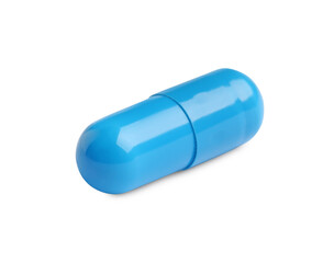 One light blue pill on white background. Medicinal treatment