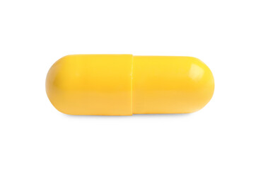 One yellow pill on white background. Medicinal treatment