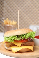 Delicious burger with tofu and fresh vegetables on white table