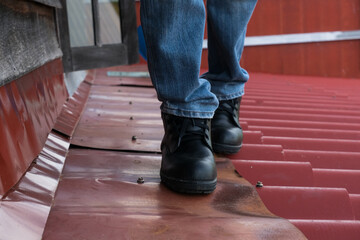 Wear safety shoes to ensure safety at work. construction workers wear safety shoes. People with...