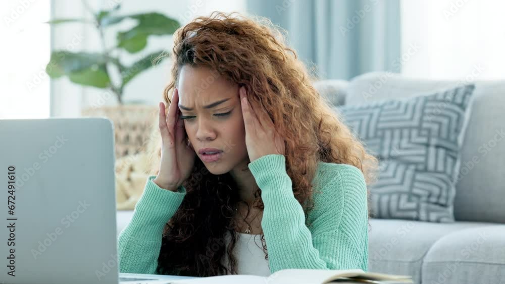 Poster A tired and overworked student with deadlines typing an assignment while sitting on a couch. A young woman struggling to cope with the workload while suffering from a headache in her house