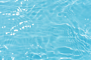 Defocus blurred transparent blue colored clear calm water surface texture with splashes reflection....