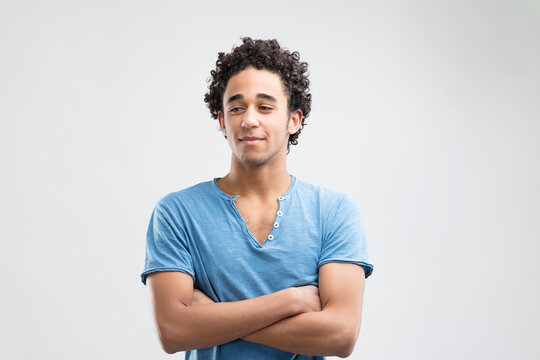 Blue-shirted person exudes serene, confident demeanor