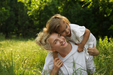 Obraz premium Beautiful mother with her cute daughter spending time together outdoors