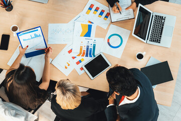 Business people group meeting shot from top view in office . Profession businesswomen, businessmen and office workers working in team conference with project planning document on meeting table . Jivy