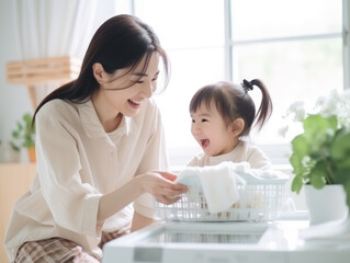 Beautiful Asain woman is happy doing housework accompanied by a cute baby