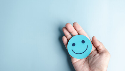 Hands holding happy smile face for medical care concept. mental health positive thinking.