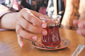 drinking Traditional turkish tea on a cafe 