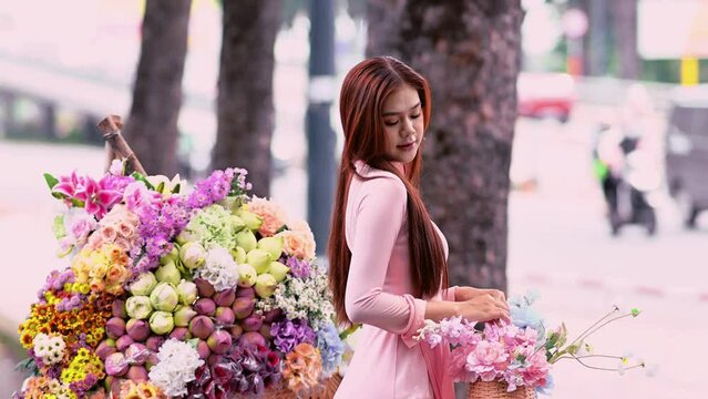 A young girl wearing a pastel pink ao dai, the traditional costume of Vietnam. Advertising video for tourism, culture, tradition, beauty of Asian