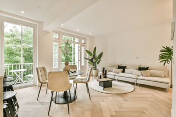 a living room with wood flooring and white furniture in the center of the room is a large window that looks out onto the - obrazy, fototapety, plakaty