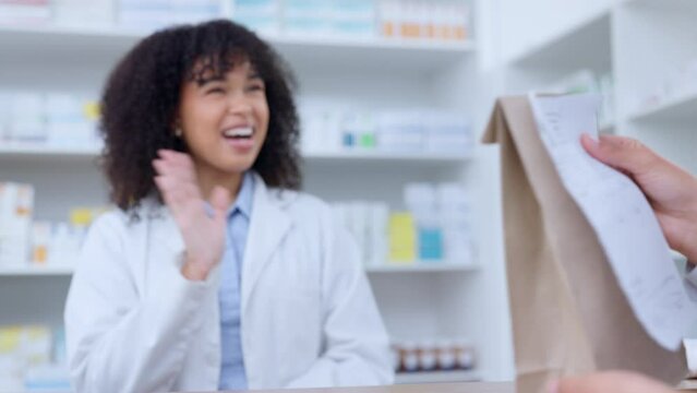 Friendly pharmacists giving prescribed medicine to a customer at a pharmacy. A woman healthcare professional handing a patient their medication at a dispensary. Medical provider passing client pills