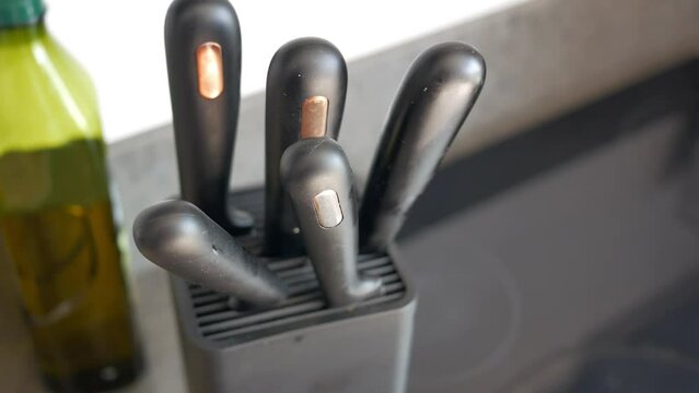 Set of kitchen knives in a box .
