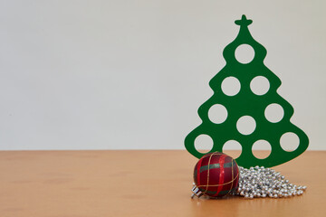 Christmas trees and Christmas ball on a wooden table white background