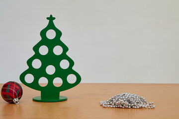 Christmas trees and Christmas ball on a wooden table white background