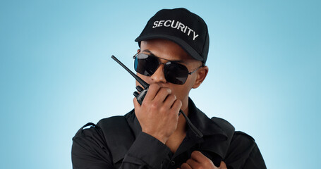 Security, radio and an officer man on a blue background in studio for surveillance or...