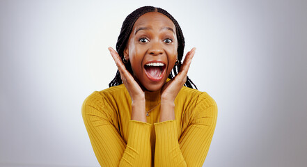 Wow, news and hands on face of black woman in studio happy with competition, prize or bonus on grey...
