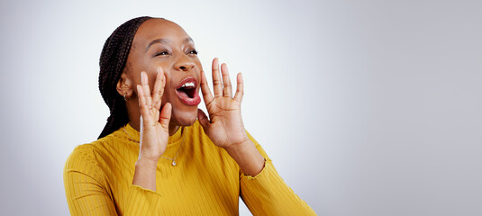 News, announcement and happy black woman shouting in studio for coming soon, deal or info on grey...