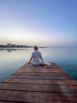 woman sitting on a pier