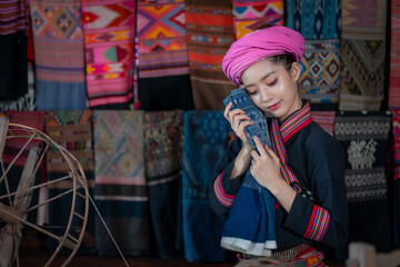 Pretty  Asian Tai Lue women beautifully wearing local dress traditional fabrics and textiles with...