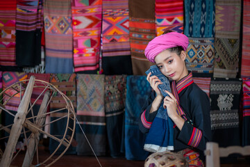 Pretty  Asian Tai Lue women beautifully wearing local dress traditional fabrics and textiles with...