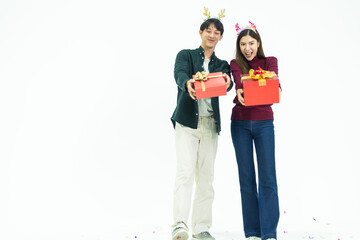 Young Asian couple two friends man woman wearing casual clothes  and holding present red box with gifts together isolated on white background studio portrait. concept new year and christmas gifts.