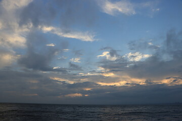 Naklejka na ściany i meble 台風が去ったあとの雲と海の夕暮れの湘南の風景