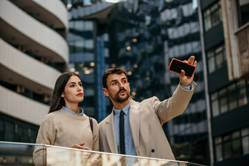 Two coworkers making future plans and chatting during a stroll in the corporate district