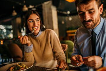 A diverse couple sharing a meal in a cozy cafe