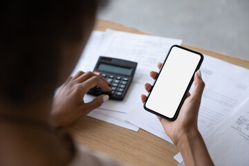 Mobile phone screen of businesswoman, entrepreneur, accountant using calculator and payment app on smartphone for paying bills, counting budget, calculating money, paying bills, taxes. Close up