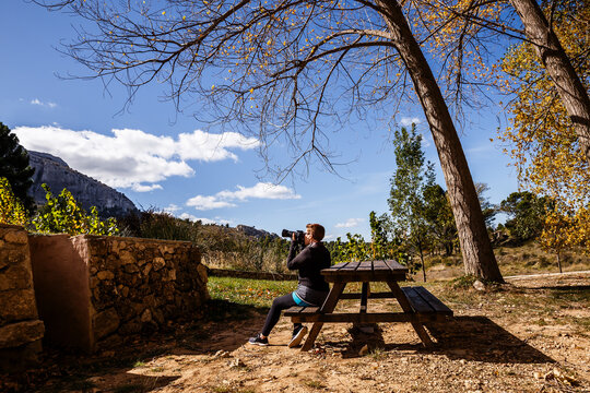 woman sitting in a picnic area taking photos