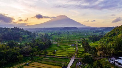 Beautiful landscape of rice paddies with Agung Volcano at sunset. Bali, Indonesia.