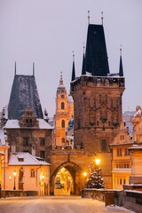 Winter twilight in Prague, snow, no one, lights on, Charles Bridge