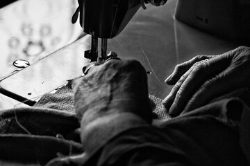 Senior woman sewing with sewing machine